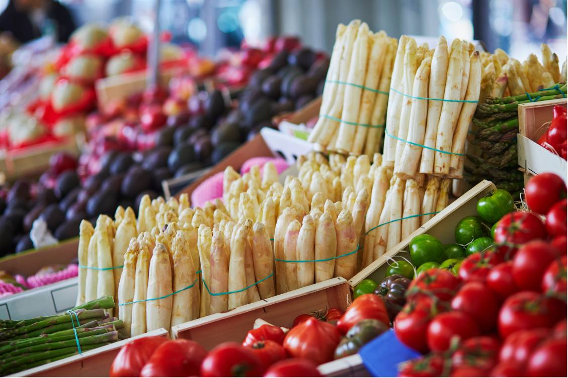 Fresh organic vegetables and fruits on farmer market in Paris, France, the much-coveted white asparagus among them.
